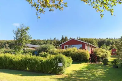 a red house with a garden in front of it at LF11171-Struer-Klintevej-14 in Struer