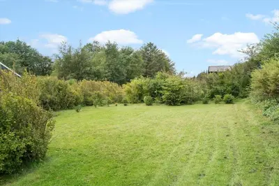 a large grass field with trees and bushes at LF11171-Struer-Klintevej-14 in Struer