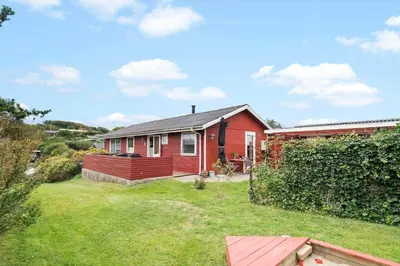 a red house with a yard in front of it at LF11171-Struer-Klintevej-14 in Struer