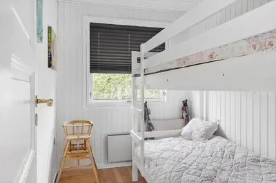 a bedroom with a bunk bed and a ladder at LF11171-Struer-Klintevej-14 in Struer