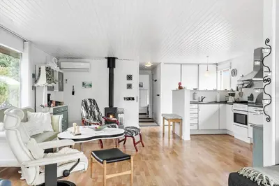 a living room with white furniture and a kitchen at LF11171-Struer-Klintevej-14 in Struer