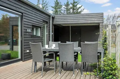 a patio with a table and chairs on a deck at LF14137-Spottrup-Fjordvej-39 in Spottrup