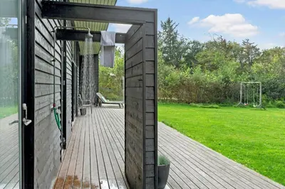 an open door to a deck with a playground at LF14137-Spottrup-Fjordvej-39 in Spottrup