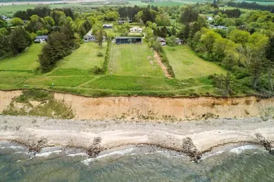 an aerial view of a house on an island in the water at LF14137-Spottrup-Fjordvej-39 in Spottrup