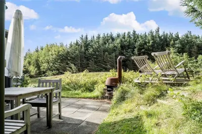 a patio with chairs and a table and an umbrella at LF11974-Struer-Havstokken-15A in Struer