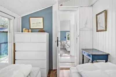 a bedroom with a bed and a blue table at LF11974-Struer-Havstokken-15A in Struer