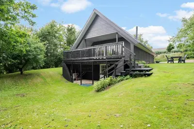 a large house with a deck on a lawn at LF11122-Struer-Plantagevej-22 in Struer