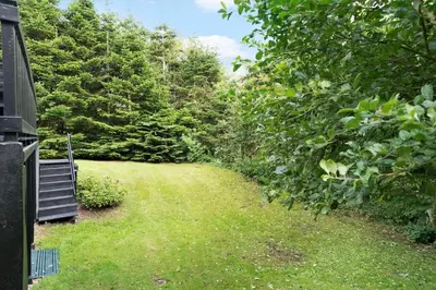 a garden with a bench in the grass at LF11122-Struer-Plantagevej-22 in Struer