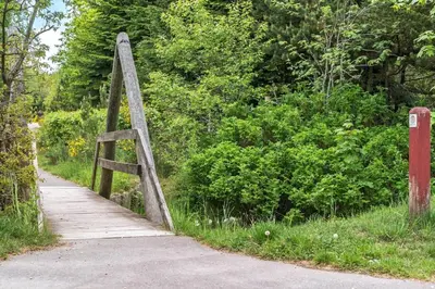a wooden bridge over a path in a park at LF10058-Thyholm-Fyrrevej-17 in Thyholm