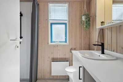 a bathroom with a white sink and a toilet at LF11107-Struer-Skovvej-7 in Struer