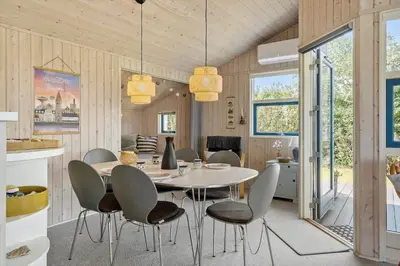 a dining room with a table and chairs at LF11107-Struer-Skovvej-7 in Struer