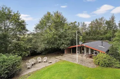 an aerial view of a house with chairs in the yard at LF15191-Hojslev-Ternevej-31 in Højslev