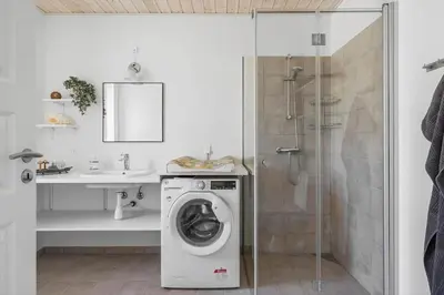 a bathroom with a washing machine and a shower at LF13174-Nykobing-mors-Feggesundvej-70 in Nykøbing Mors
