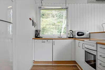 a white kitchen with a sink and a window at LF13172-Nykobing-M-Strandvaenget-76 in Ejerslev