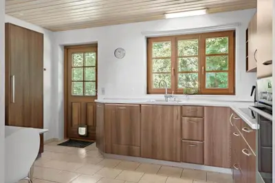 a kitchen with wooden cabinets and a sink at LF11597-Struer-Plantagevej-97 in Struer