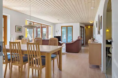a dining room and living room with a table and chairs at LF11597-Struer-Plantagevej-97 in Struer