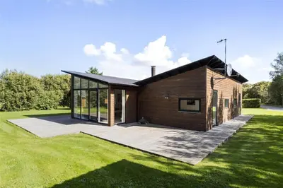 a small wooden house on a grass field at LF530-Vestervig-Hannesvej-30 in Vestervig