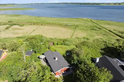an aerial view of a house and the water at LF10221-Thyholm-Haervej-21 in Thyholm