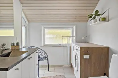 a kitchen with a sink and a washing machine at LF10210-Thyholm-Skovstien-10 in Thyholm