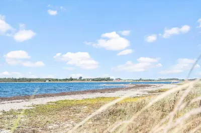 a view of a beach with water and grass at LF10210-Thyholm-Skovstien-10 in Thyholm