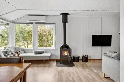a living room with a wood stove in a room at LF11108-Struer-Barsidalvej-8 in Struer
