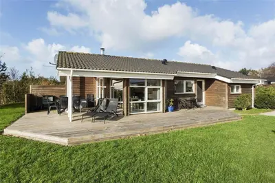 a house with a wooden deck in the yard at LF884-Snedsted-Kongens-Borer-2 in Snedsted