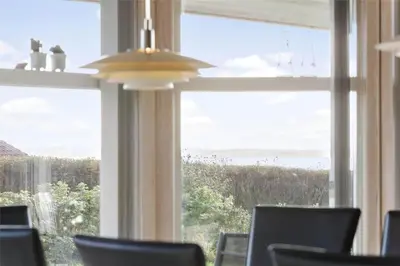 a room with a large window with a view of the ocean at LF884-Snedsted-Kongens-Borer-2 in Snedsted