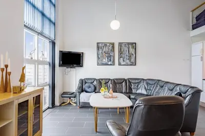 a living room with a leather couch and a table at LF14211-Roslev-Vile-Vestergardvej-34-Lejl-A-tv in Roslev