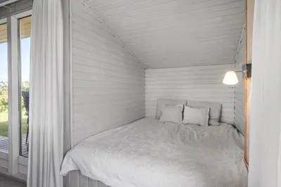 a white bed in a room with a window at LF11111-Struer-Granvej-11 in Struer
