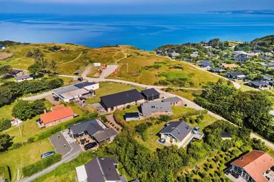 an aerial view of a house on a hill next to the ocean at LF11111-Struer-Granvej-11 in Struer