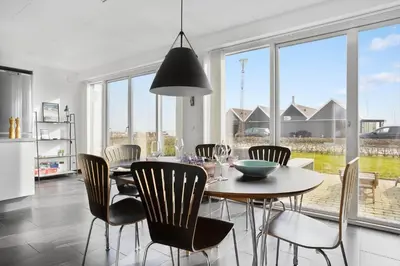 a kitchen and dining room with a table and chairs at LF10214-Thyholm-Havnefronten-14 in Thyholm
