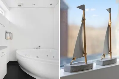 a bathroom with a white tub and a sailboat on a counter at LF10214-Thyholm-Havnefronten-14 in Thyholm