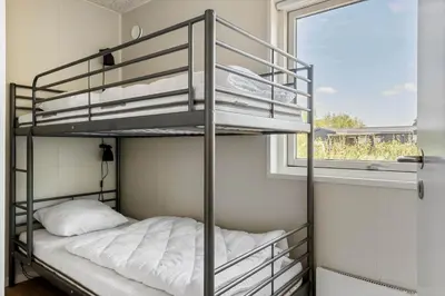 a bedroom with two bunk beds and a window at LF12086-Vinderup-Vigen-86 in Vinderup