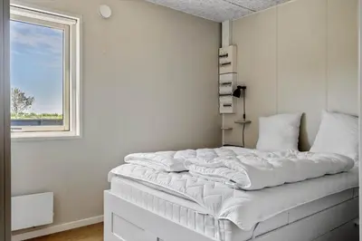 a white bed in a room with a window at LF12086-Vinderup-Vigen-86 in Vinderup