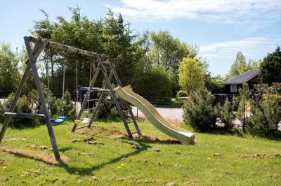 a playground with a slide in the grass at LF12086-Vinderup-Vigen-86 in Vinderup