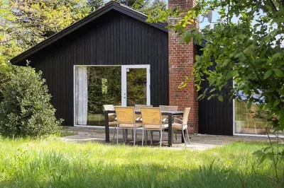 a table and chairs in front of a building at LF14138-Spottrup-Heden-11 in Spottrup
