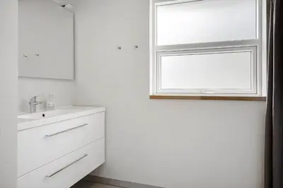 a white bathroom with a sink and a window at LF10302-Hurup-Thy-Skibstedsvej-22-B in Sønder Ydby