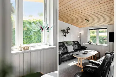 a living room with a couch and a table at LF11103-Struer-Blabaervej-3 in Struer