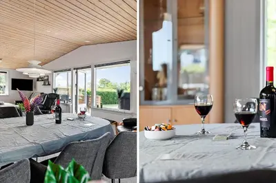 a table with a bottle of wine and two glasses of wine at LF11103-Struer-Blabaervej-3 in Struer