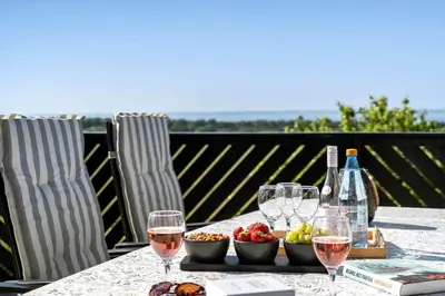 a table with wine glasses and fruit and wine bottles at LF10301-Hurup-Thy-Sindrupvej-1-B in Sindrup