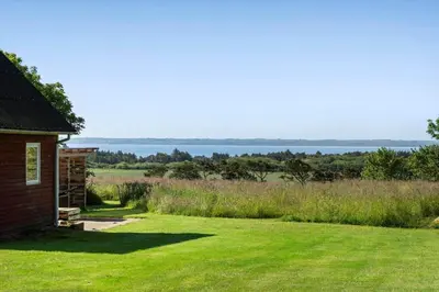 a house with a yard with a view of the water at LF10301-Hurup-Thy-Sindrupvej-1-B in Sindrup
