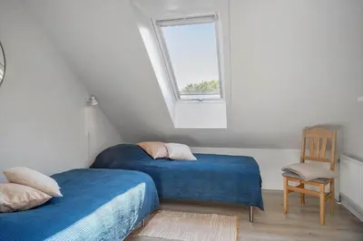 a attic bedroom with two beds and a window at LF10301-Hurup-Thy-Sindrupvej-1-B in Sindrup