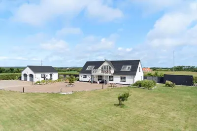 a large white house with a black roof at LF10234-Thyholm-Jestrupvej-19 in Thyholm