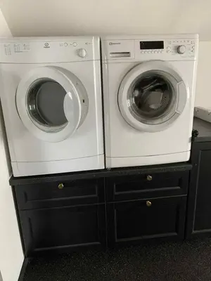 two washing machines are sitting on top of cabinets at Købmandsgården i Blære in Års