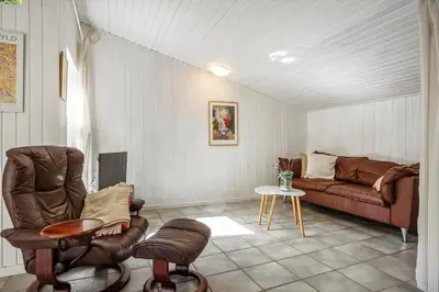 a living room with a couch and a table at LF0027-Thyholm-Sondbjerg-Strandvej-27 in Thyholm