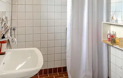 a bathroom with a white shower curtain and a sink at Beautiful Home In Pandrup With Wifi in Pandrup