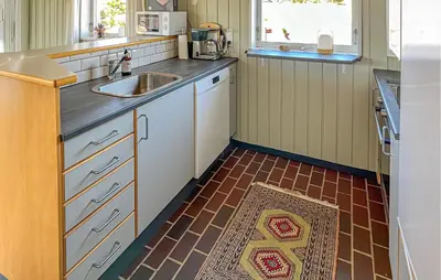 a kitchen with a sink and a counter top at Beautiful Home In Pandrup With Wifi in Pandrup