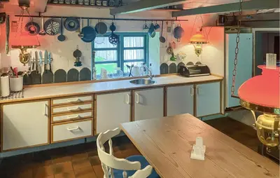 a kitchen with a wooden table and a wooden table sidx sidx sidx at Gorgeous Home In Vemb With Wifi in Vemb