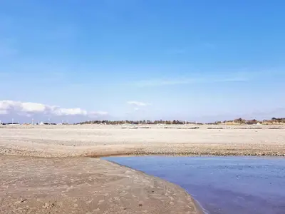 a beach with a pool of water in the sand at 10 person holiday home in Ranum in Ranum
