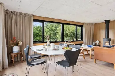 a dining room with a white table and chairs at BL1116-Blokhus-Bloksbjerg-24 in Blokhus